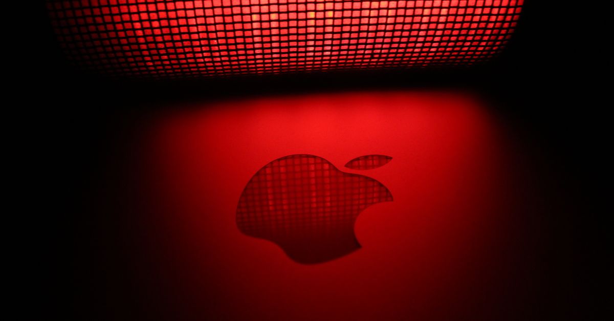 Artistic photo of a glowing apple-shaped graphic with a checkered pattern and red background.