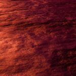 A captivating abstract view capturing the crimson texture of ocean waves illuminated by sunset.