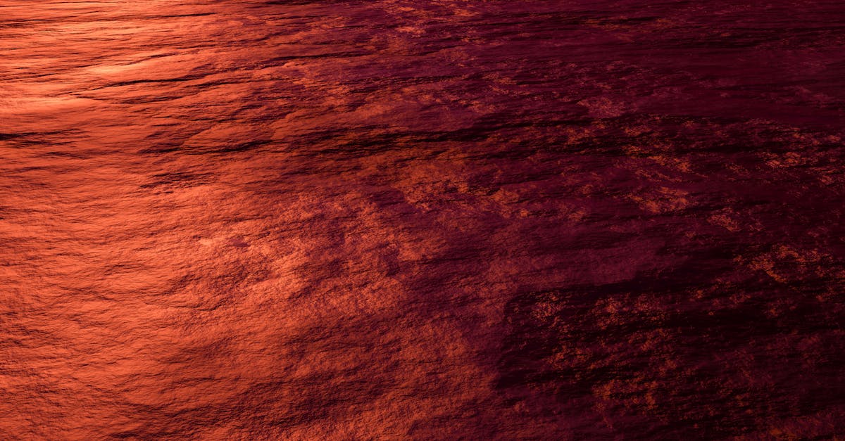 A captivating abstract view capturing the crimson texture of ocean waves illuminated by sunset.