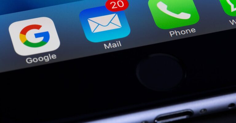 A close-up photo of a smartphone displaying popular apps like Google and Mail.