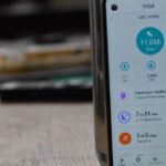 Close-up of a smartphone displaying a fitness tracking app with health statistics.