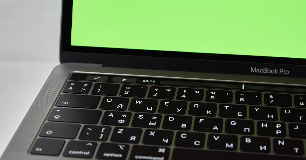 Russian keyboard MacBook Pro with a green screen. Modern electronic device.