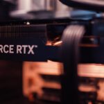 Detailed view of a GeForce RTX graphics card installed in a computer setup, highlighting modern technology.