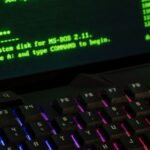 Close-up of a retro computer screen displaying MS-DOS commands with a vibrant keyboard.