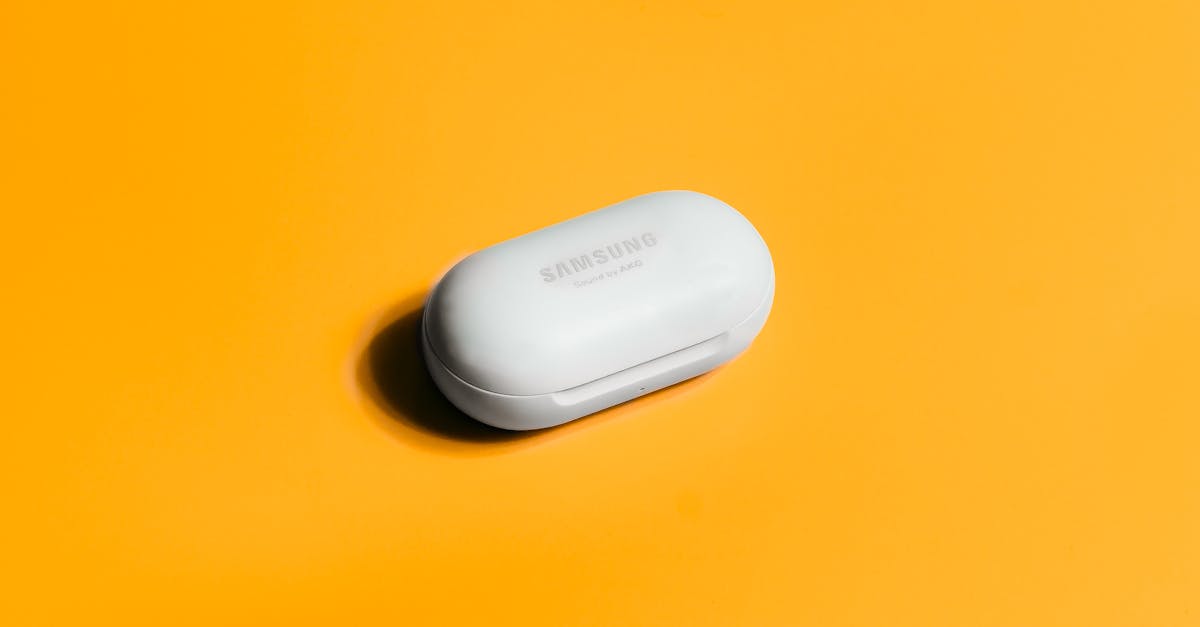 White Samsung wireless earbuds case on a bright yellow background, showcasing sleek tech design.