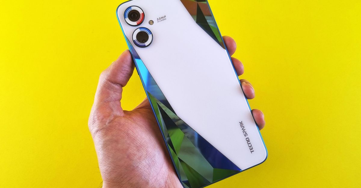 Close-up of a smartphone held in hand against a vibrant yellow background, showcasing modern design.