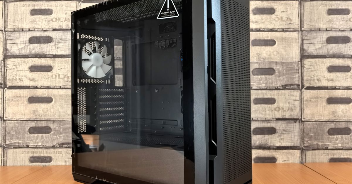 A modern black computer case with tempered glass panel on a wooden desk, ideal for tech enthusiasts.