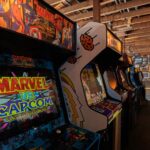 Modern arcade machines with bright luminous monitors and inscriptions in contemporary public entertainment center