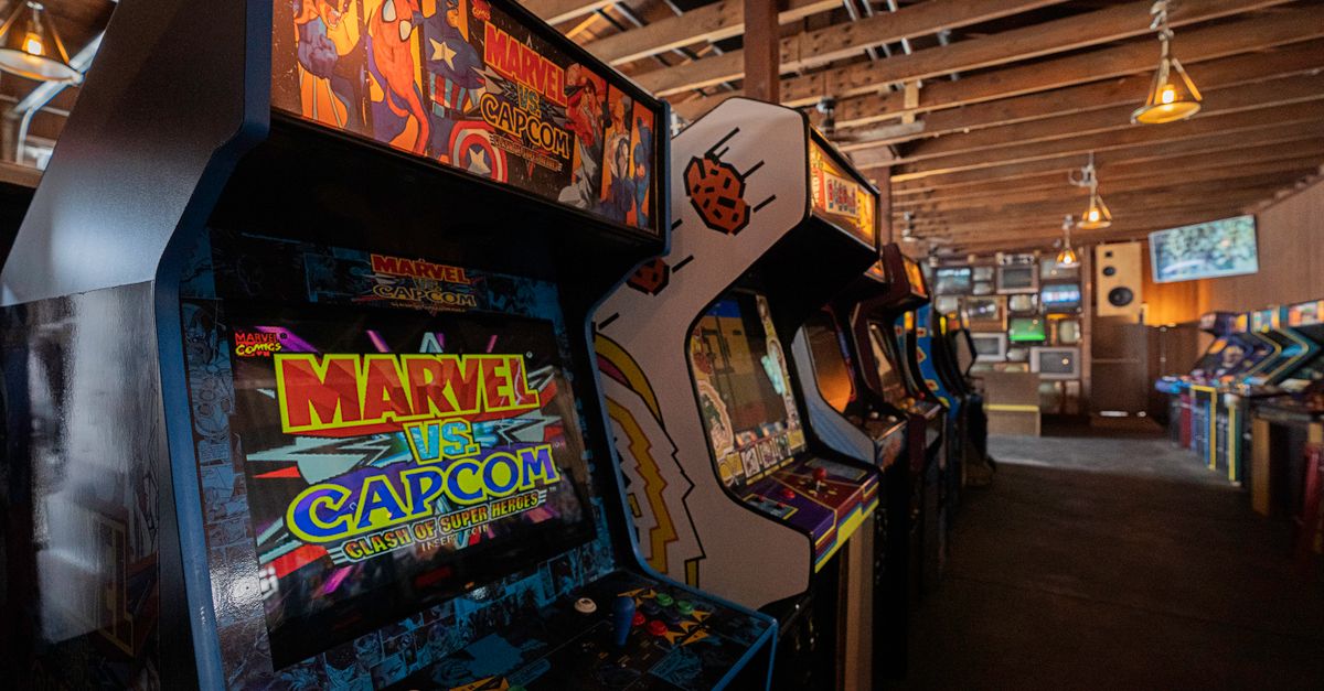 Modern arcade machines with bright luminous monitors and inscriptions in contemporary public entertainment center