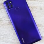 A vibrant blue Lenovo smartphone on a light textured background, showcasing its sleek design and modern technology.