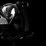 Elegant black and white photo of a CPU cooler with dramatic shadows, perfect for technology themes.